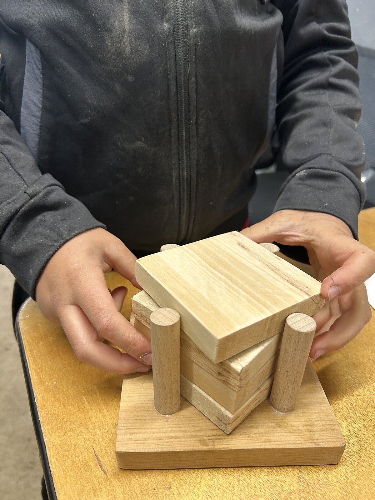 A young person holding a finished joinery project made in the Wild Minds workshop